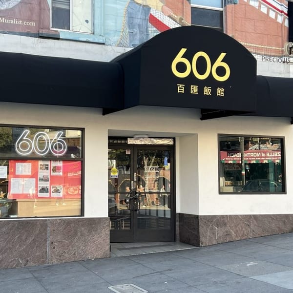 The exterior of 606 Chinese restaurant, featuring a black awning with the number 606 in yellow.
