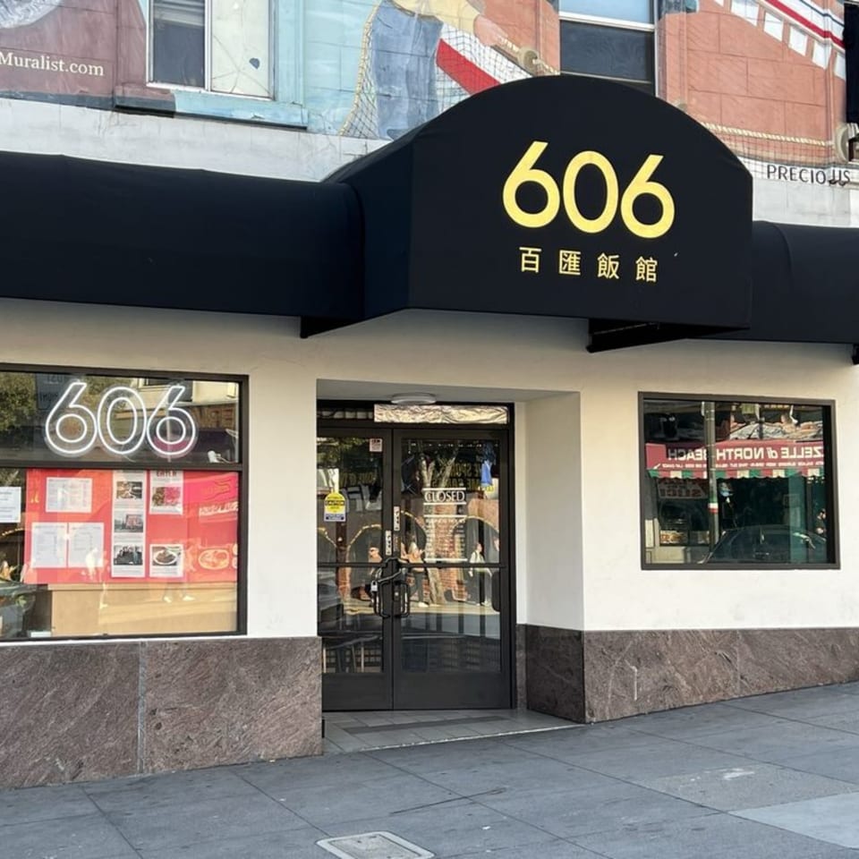 The exterior of 606 Chinese restaurant, featuring a black awning with the number 606 in yellow.